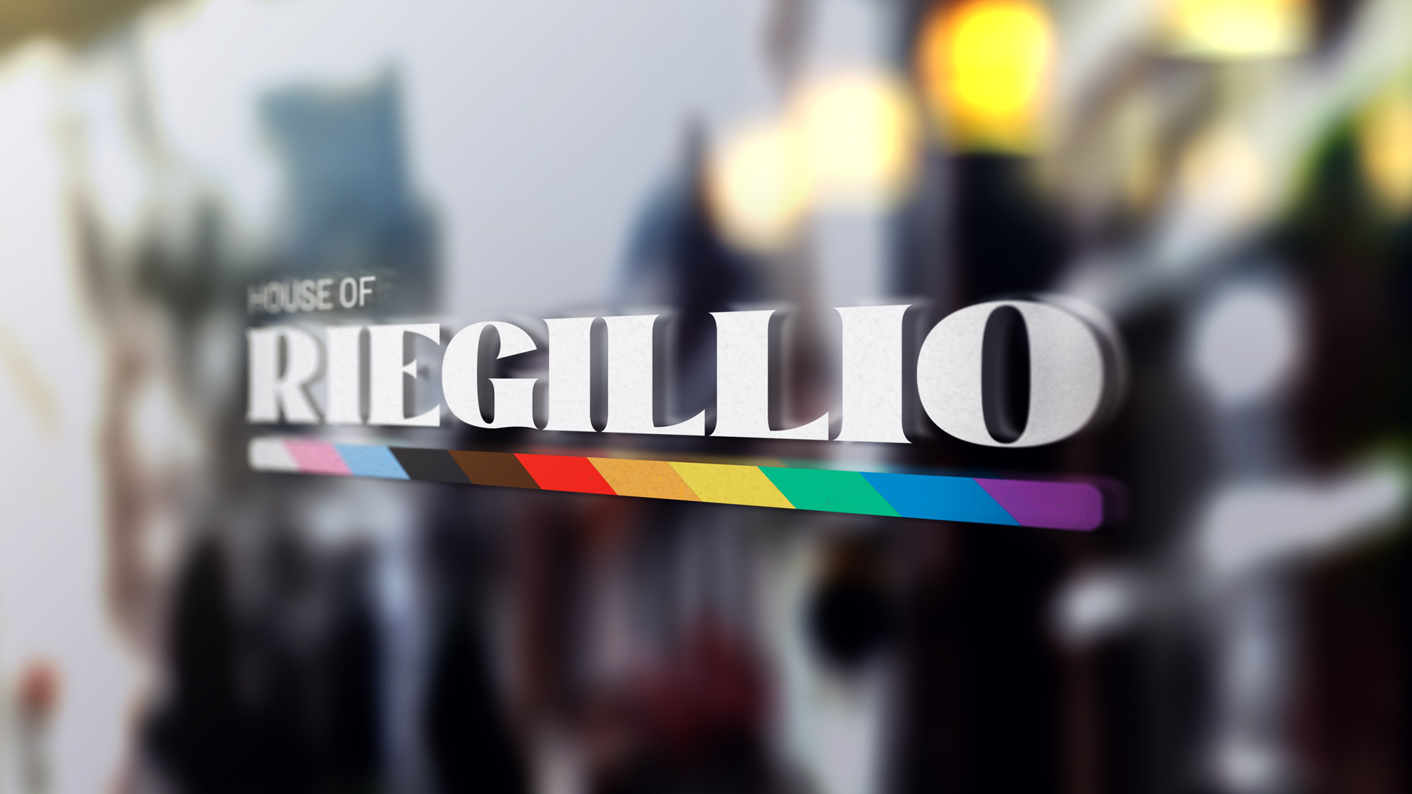 Window decal with the text 'House of Riegillio' and a horizontal rainbow-colored stripe below the text.