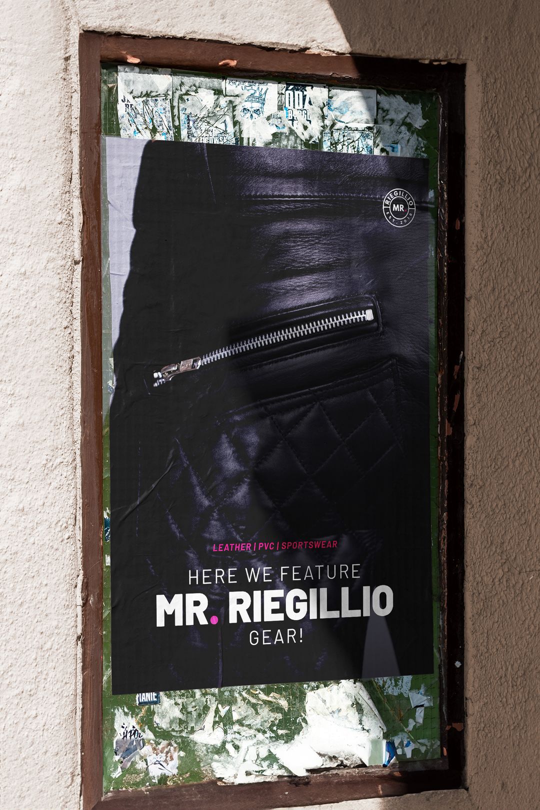 Poster featuring a close-up of a black leather jacket zipper with text highlighting MR. RIEGILLIO gear in leather, PVC, and sportswear.