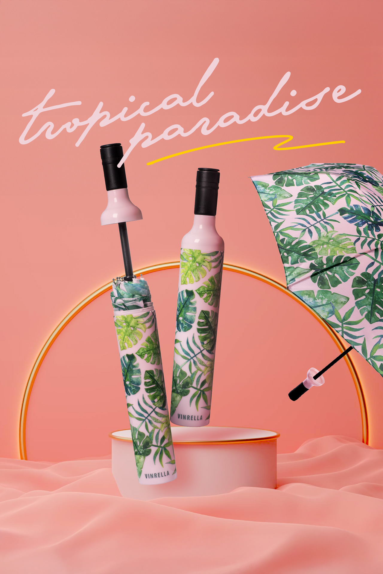 Compact umbrellas with tropical green leaf pattern and pink bottle-shaped handles against a pink background with 'tropical paradise' text.