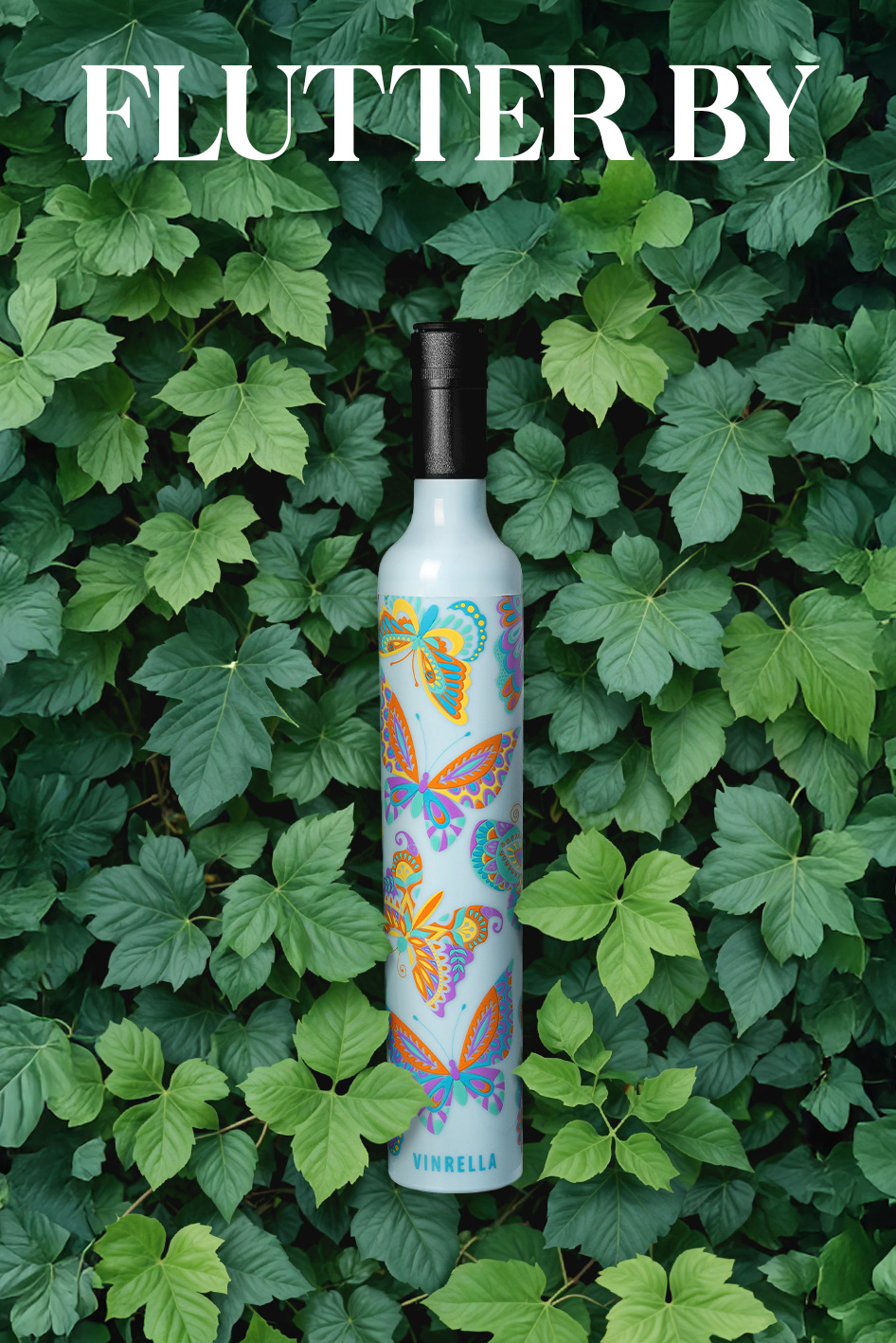Vinrella bottle with colorful butterfly designs placed upright among lush green leaves with text 'FLUTTER BY' above.
