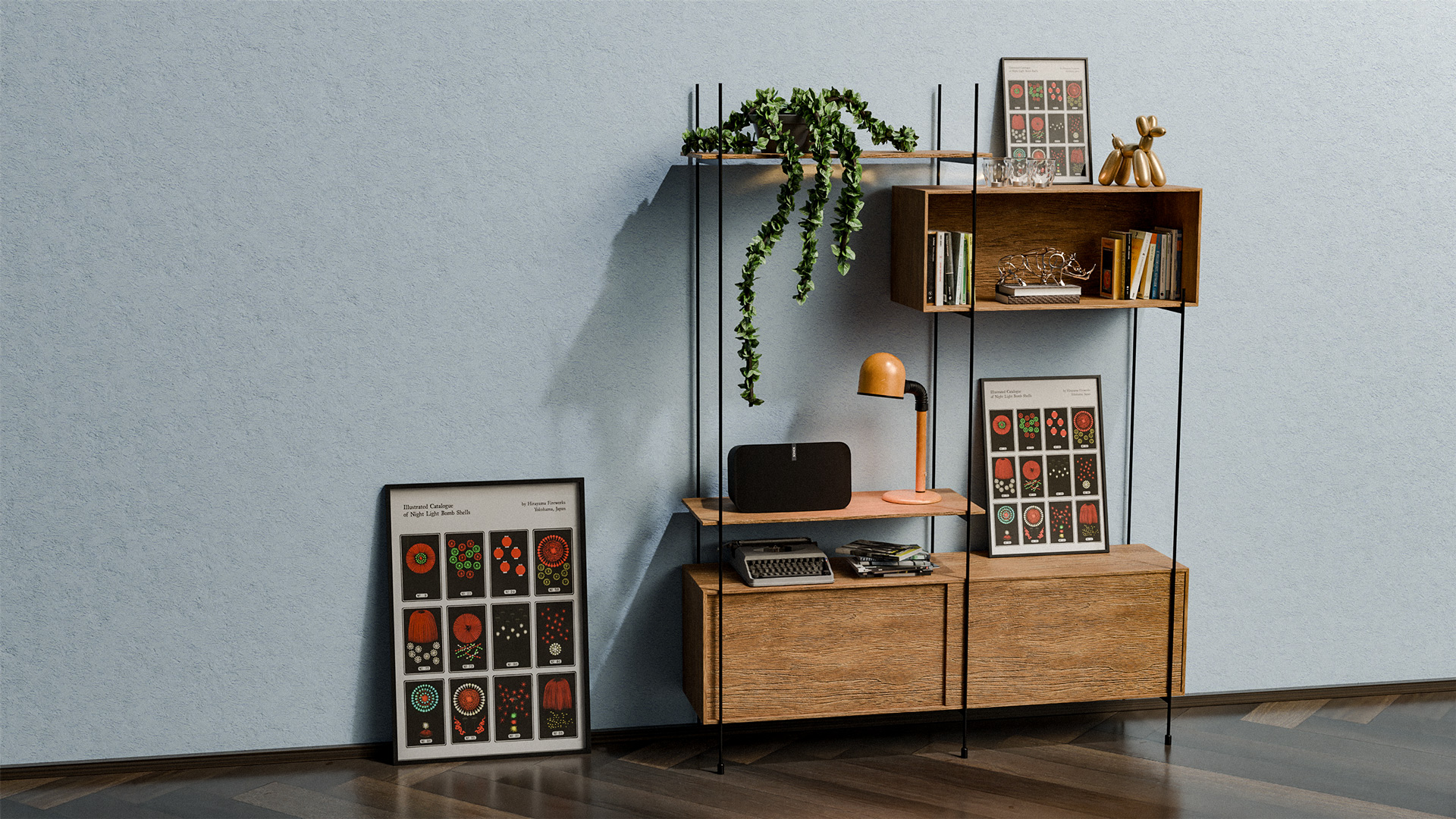 Wooden shelving unit with a hanging plant, orange desk lamp, black speaker, typewriter, books, decorative sculptures, and framed colorful fireworks illustrations leaning against and on the shelves in a room with light blue walls and dark wooden floor.