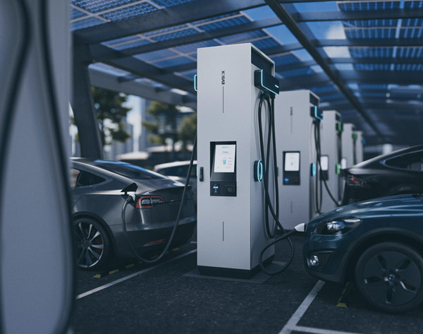EVBox Ultroniq electric vehicle charging station with multiple charging units and electric cars plugged in under a solar panel canopy.