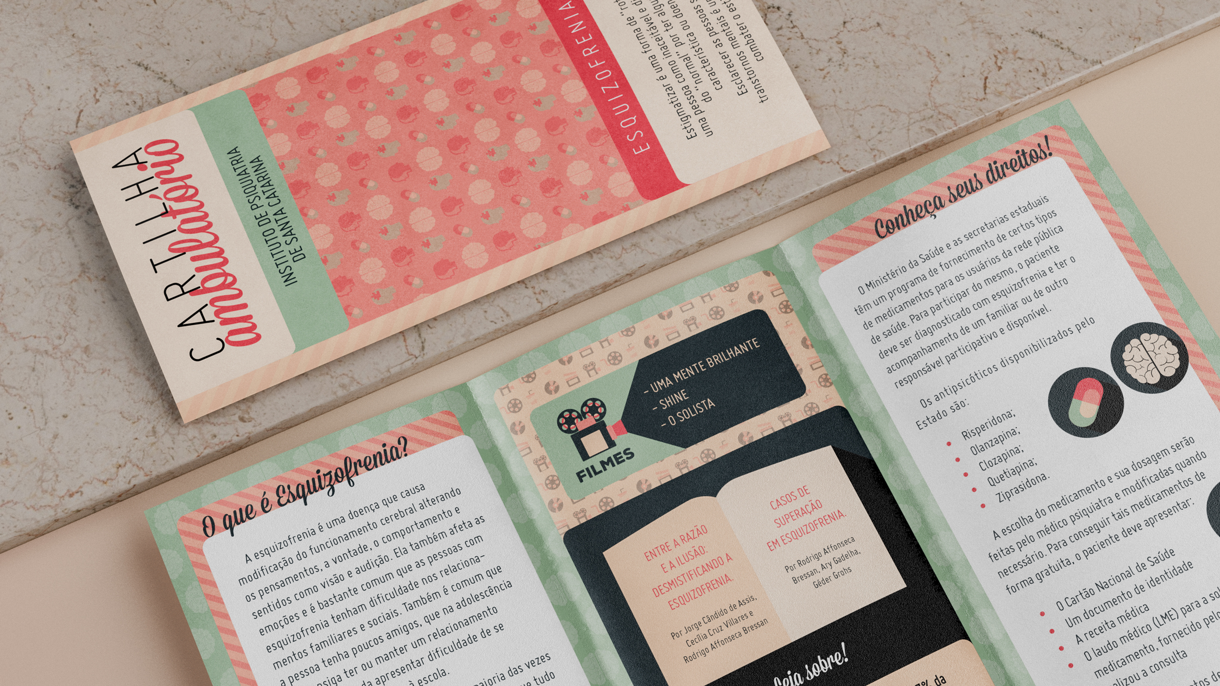 Brochure open on a marble surface with information in Portuguese about schizophrenia, including sections on what schizophrenia is, recommended films, and patients' rights.