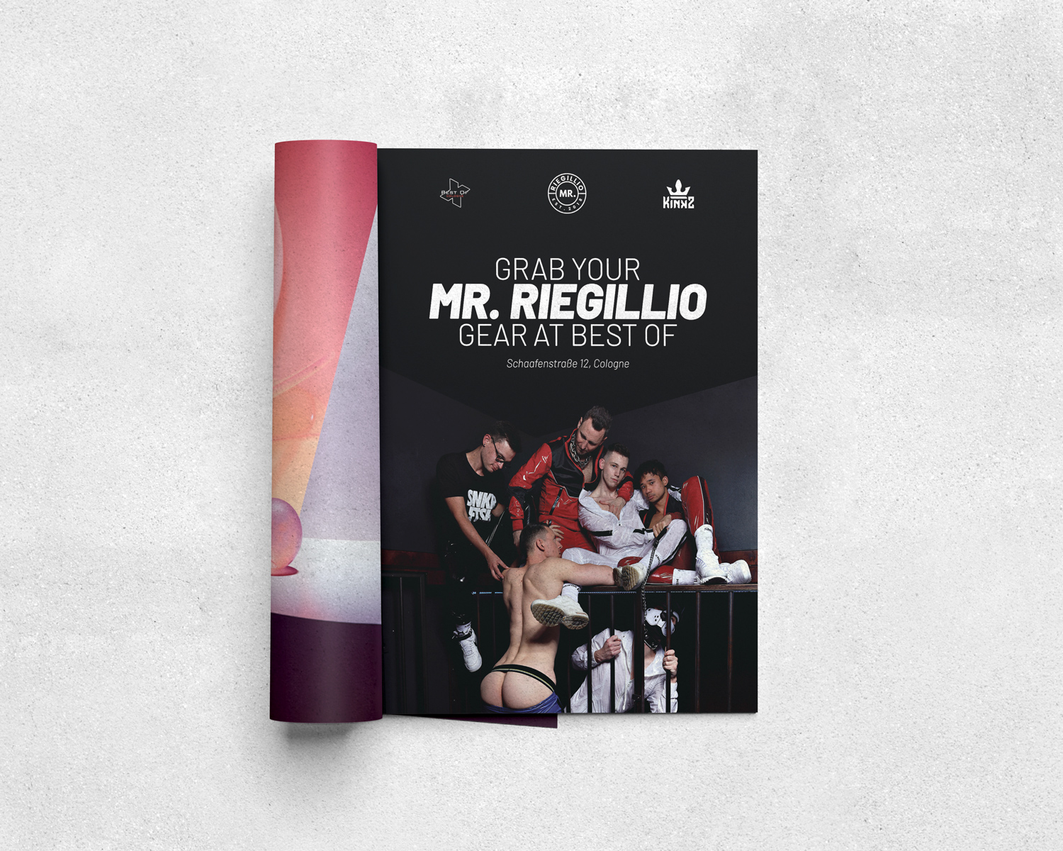 Magazine opened to an ad with five men, one shirtless and wearing underwear, others in leather and casual outfits, promoting Mr. Riegillio gear at Best Of in Cologne.