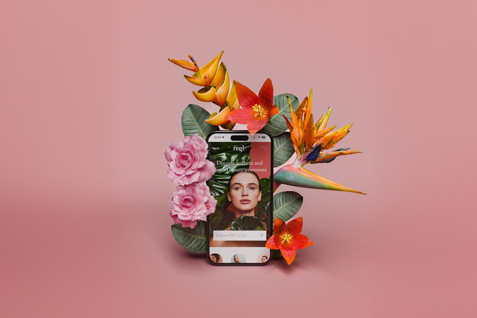 Smartphone displaying a beauty app screen surrounded by vibrant tropical flowers and green leaves on a pink background.