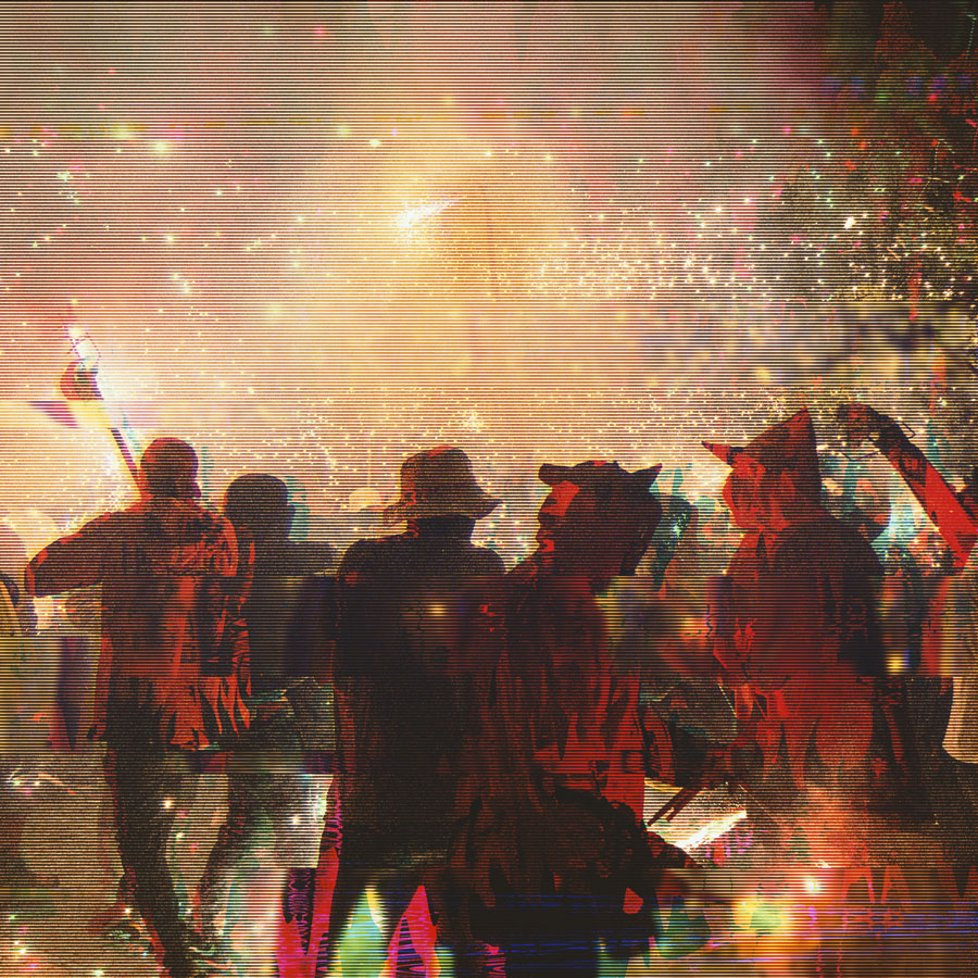 Group of people silhouetted against bright, colorful fireworks and sparkling lights at a night celebration.