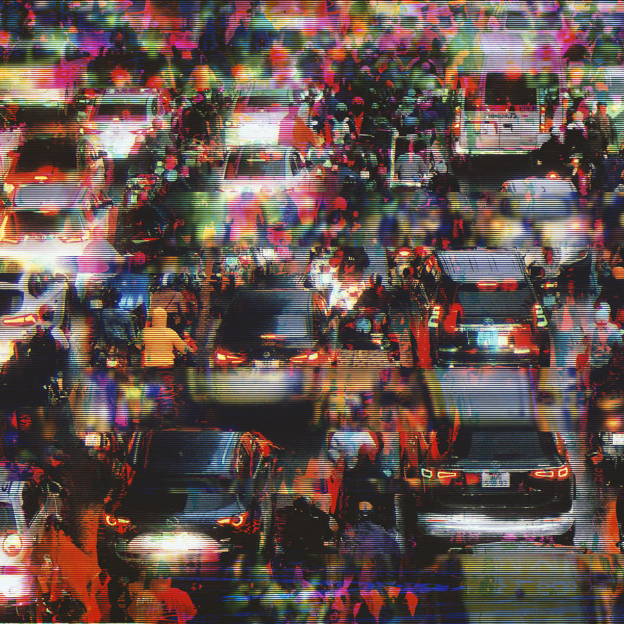 Blurred and colorful image of heavy traffic with cars and motorcycles on a crowded street.